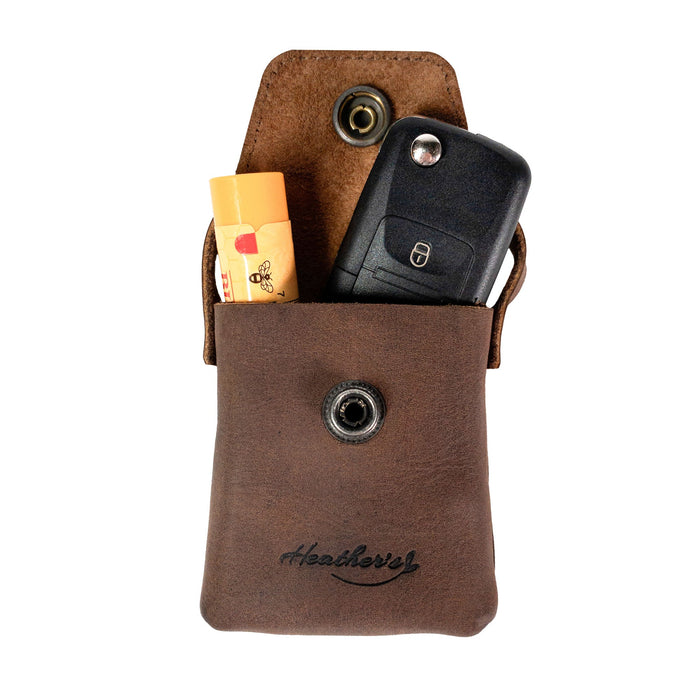 Inside view of Heather's Mini Purse-Shaped Keychain holding keys and essential items. This mini purse keychain for women is made from full grain leather, offering a vintage style keyring holder ideal for organization. Handmade in La Antigua Guatemala & Oaxaca Mexico.