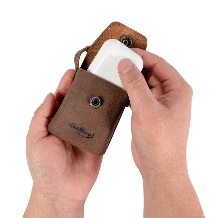 Heather's Mini Purse-Shaped Keychain being opened to retrieve items, demonstrating its practical design. This full grain leather accessory serves as a mini purse keychain for women, blending vintage charm with functionality, and features artisan craftsmanship from La Antigua Guatemala & Oaxaca Mexico.