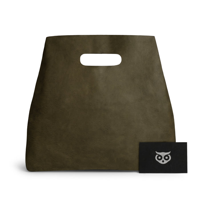 Showing the Minimalist Boho Handbag from Hide & Drink with a stylish card, displaying the brand identity. This Minimalist Handbag for Women exemplifies a functional Rustic Purse, made from durable Full Grain Leather, representative of StockyardX's artisan craftsmanship through Hand Cut, Hand Sewn processes, made in La Antigua Guatemala & Oaxaca Mexico.