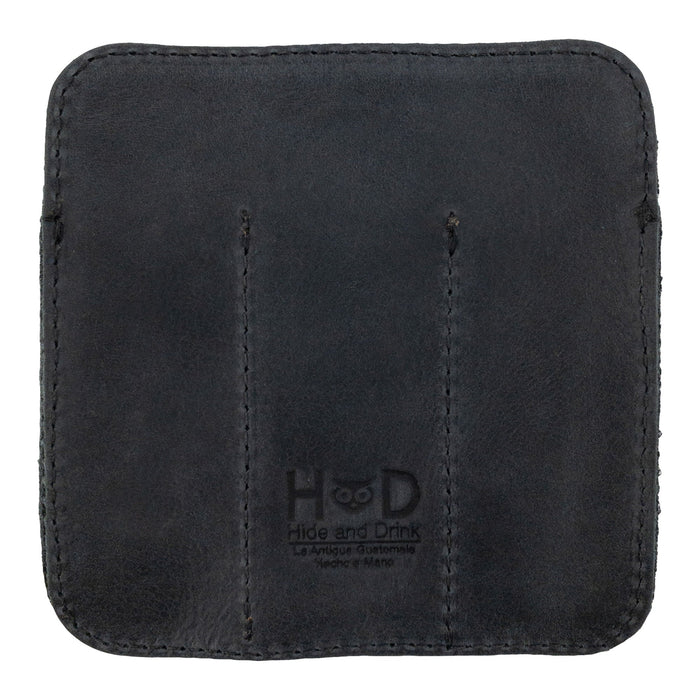 Reverse side of the Hide & Drink Minimalist Tool Pocket featuring its branding. This durable Tool Pocket Pouch made from Full Grain Leather represents the artisan craftsmanship of StockyardX, emphasizing handmade quality from La Antigua Guatemala in small batch production.