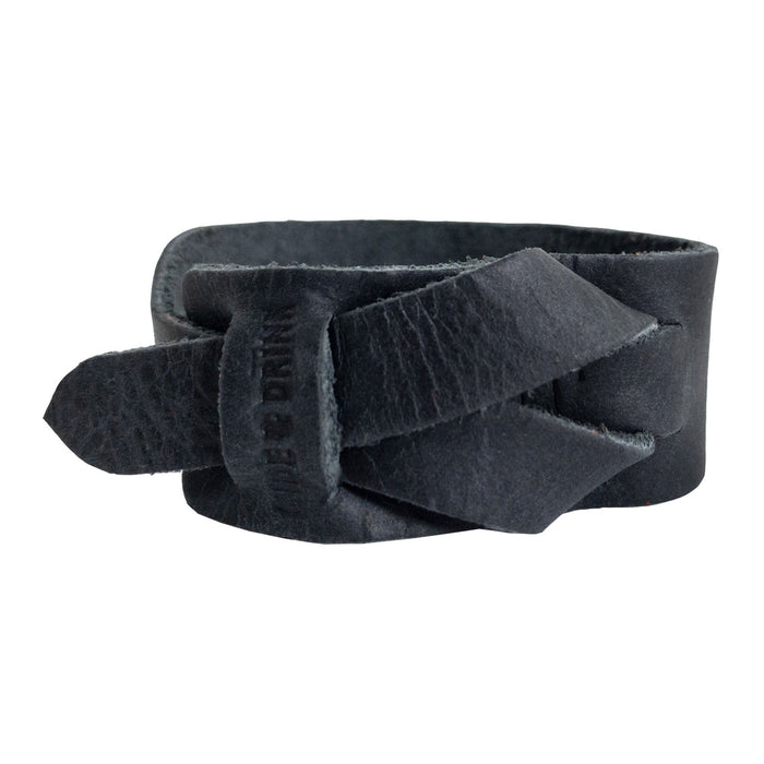 Hide & Drink's Minimalist Wristband captured in a sleek black full grain leather variation. This stylish cuff features a unique texture and adjustable strap, handcrafted by artisans in La Antigua Guatemala. An elegant bracelet by StockyardX representing small batch production and artisan quality.