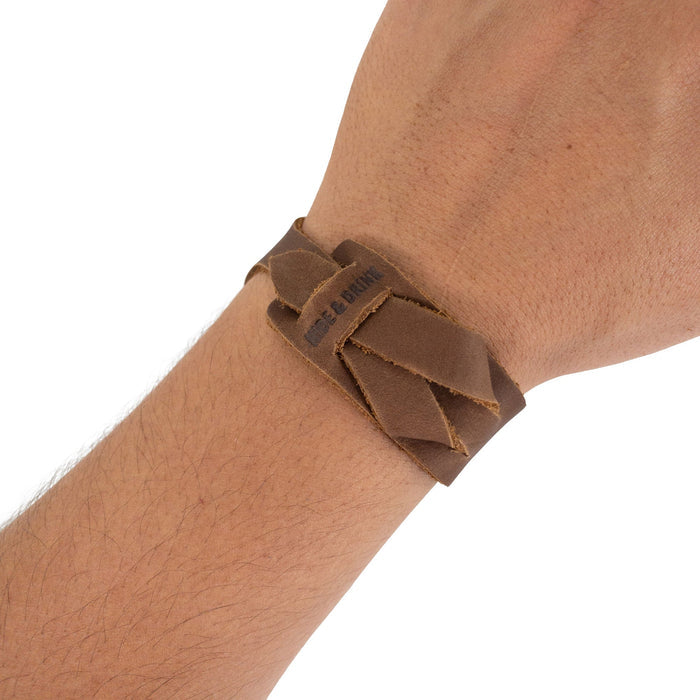 Hide & Drink‚Äôs Minimalist Wristband worn, showcasing the light brown leather‚Äôs unique tone and handcrafted quality. This adjustable cuff is a stylish bracelet that embodies artisan craftsmanship and care from StockyardX in La Antigua Guatemala.