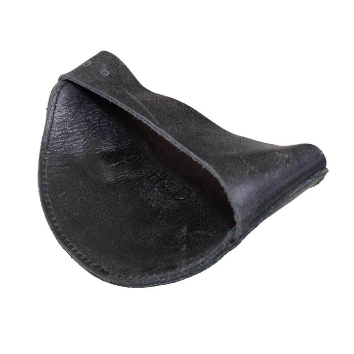 Underside of the black Motorcycle Boot Protector by Hide & Drink, demonstrating its sturdy design and purpose to safeguard shoes from shifter wear. This shoe cover is crafted from full grain leather, ensuring durability and authenticity in every stitch, handmade in La Antigua Guatemala.