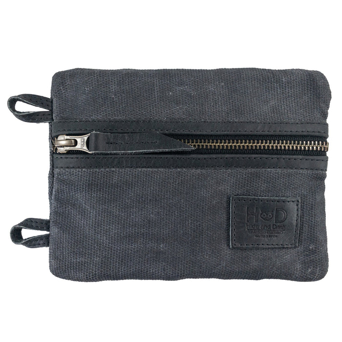Side view of the black Multi-tool Pocket Pouch - XL by Hide & Drink, highlighting the zippered closure designed for easy access to tools and hardware. Multi-Tool Pocket Pouch XL, Compact Multipurpose EDC Zippered Bag, Mini Camping Tool Case, Knife Holster, Handmade Slim Organizer, Waxed Canvas, StockyardX, Small Batch Production, Artisan, Handmade in La Antigua Guatemala & Oaxaca Mexico.
