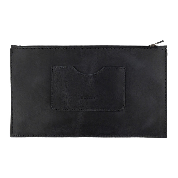 A frontal view of a black rectangular zippered handbag by Hide & Drink, showcasing its sophisticated design. This female purse includes a card slot, made from high-quality full grain leather, reflecting small batch production and artisan craftsmanship. Handmade in La Antigua Guatemala & Oaxaca Mexico.