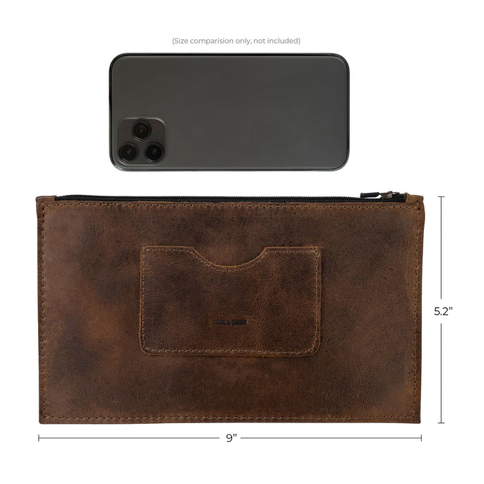 Size comparison of a brown rectangular zippered handbag by Hide & Drink next to an iPhone, showcasing its dimensions. Designed for women, this full grain leather female purse features a card slot, highlighting the skillful handmade craftsmanship in small batch production, typical of artisans from La Antigua Guatemala & Oaxaca Mexico.