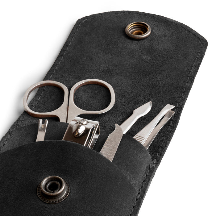 Close-up shot of the black Hide & Drink Nail Clipper Case with tools, highlighting its elegant full grain leather. A luxurious travel accessory, it features artisan craftsmanship with small batch production, hand cut, hand sewn, and fire branded, made in La Antigua Guatemala & Oaxaca Mexico.