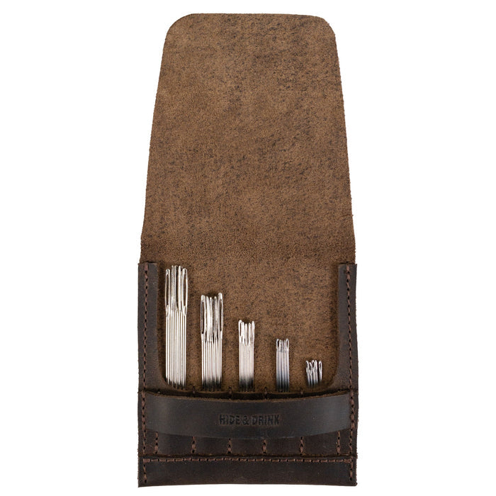 Open view of the Needle Case by Hide & Drink displaying various compartments for needles. Made from Full Grain Leather, this handmade piece represents small batch production and the skilled craftsmanship of artisans in La Antigua Guatemala & Oaxaca Mexico.