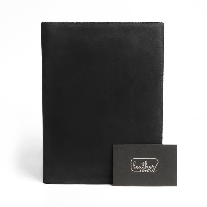 Front view of the black Leather Worx Notepad Case 5 x 8 In. with a branding detail, paired with a card showcasing its artisan craftsmanship. Notepad Cover (5 x 8 In. Notepad Not Included) Sturdy, Durable Material Perfect for Storing Journal, Full Grain Leather, StockyardX, Small Batch Production, Hand Cut, Hand Sewn, Fire Branded, Artisan, Handmade in La Antigua Guatemala & Oaxaca Mexico.