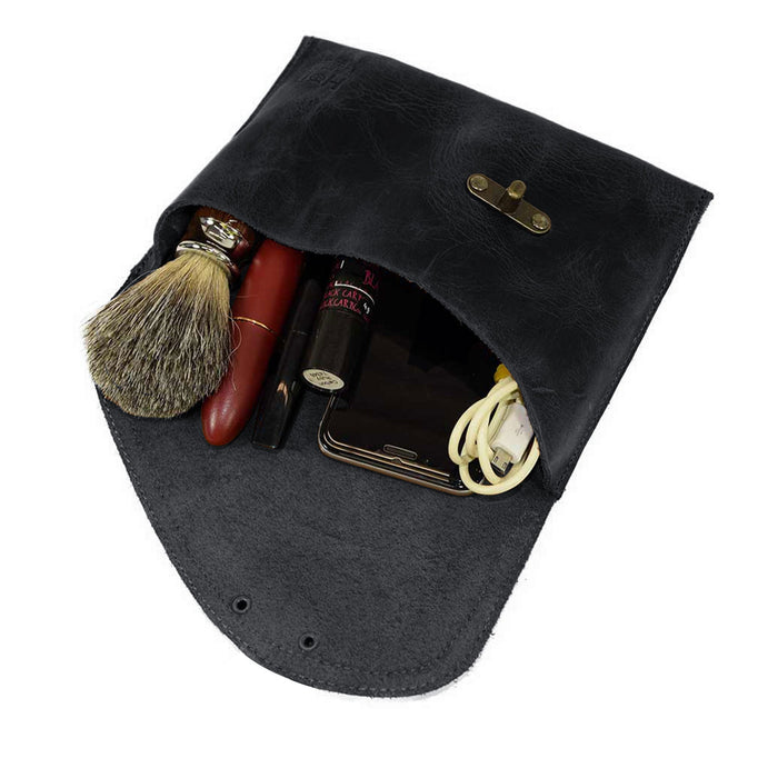 The Petite Vintage Clutch Bag by Hide & Drink, with its interior filled with essentials, demonstrates its practicality as a travel accessory. Crafted from full grain leather and handmade in La Antigua Guatemala & Oaxaca Mexico, it‚Äôs a beautiful blend of style and function.