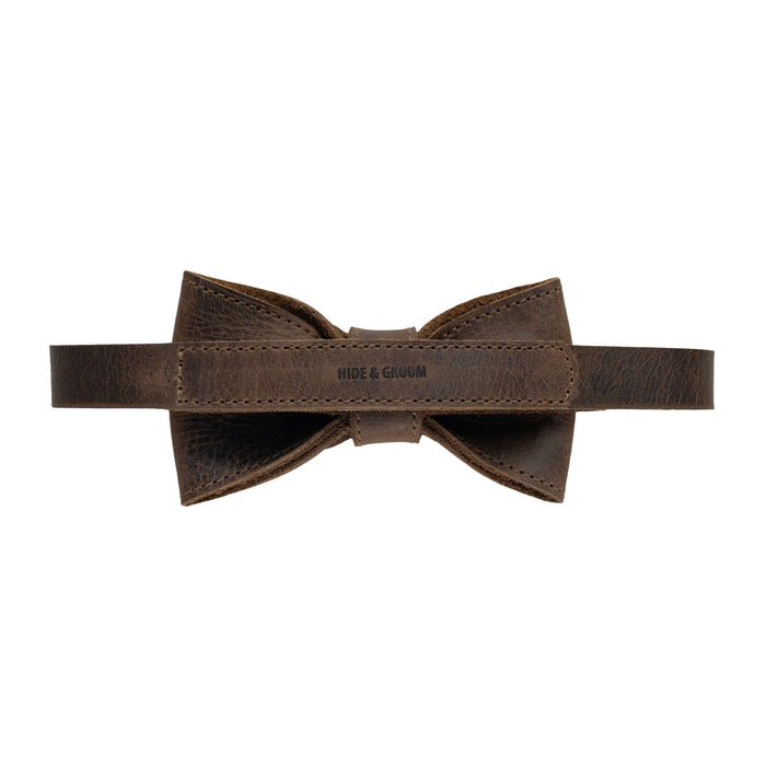 Back view of the Pointed Bow Tie for Groomsmen by Hide & Groom with a clear brand label, emphasizing the hand-sewn finish in full grain leather. This artisan-made bow tie is ideal for formal occasions, blending style and durability for discerning men, embodying small batch production from La Antigua Guatemala & Oaxaca Mexico.