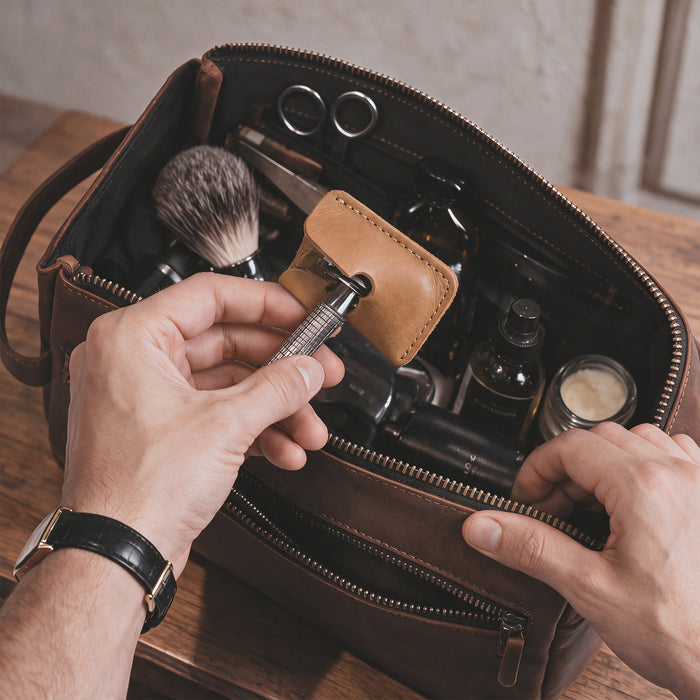 Hide & Drink Razor Head Cover displayed alongside a double edge safety razor, crafted from full grain leather. This handmade protective sheath is perfect for travel, highlighting the artisan quality and small batch production from La Antigua Guatemala and Oaxaca Mexico.