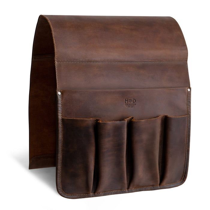 The sleek design of Hide & Drink‚Äôs Remote Control Holder displays its durable full grain leather, featuring spacious compartments for easy access to essentials like remotes and magazines. Perfect as an armchair caddy, this handmade item symbolizes small batch production expertise.