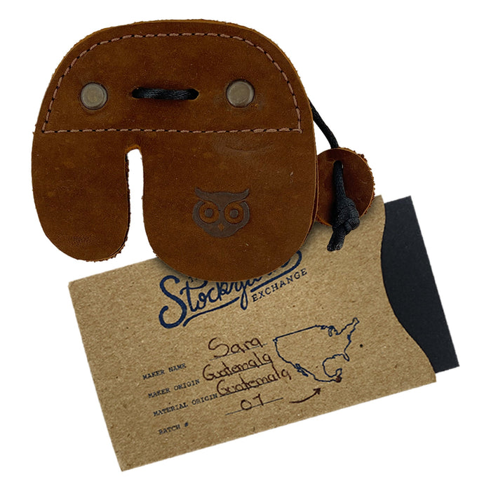 Right Handed Archery Finger Protector by Hide & Drink, a beautifully crafted archery finger tab using full grain leather. This stylish finger protector ensures optimal protection as a guard for recurve bows, enhancing your shooting practice gear sports & outdoors. Artisan craftsmanship shines through in its hand cut and hand sewn detail, reflecting small batch production and fire branding, handmade in La Antigua Guatemala.