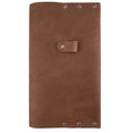 Front view of the Riveted Journal Cover (5 x 8.50 in.) by Hide & Drink. This classic sleeve in vintage style features full grain leather, showcasing the artisanal craftsmanship with hand cut and hand sewn details. Perfect for your notebook, this product embodies small batch production from La Antigua Guatemala & Oaxaca Mexico.