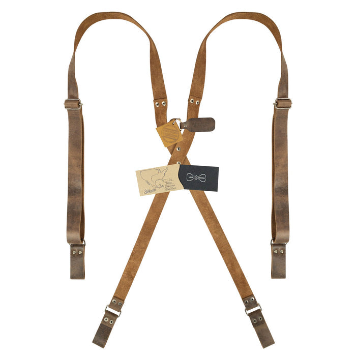 Riveted X Back Suspenders with Belt Loops by Hide & Groom, presented with care instructions and artisan tags. A perfect addition to any wardrobe, these heavy-duty, handmade full grain leather suspenders highlight the beauty of small batch production.