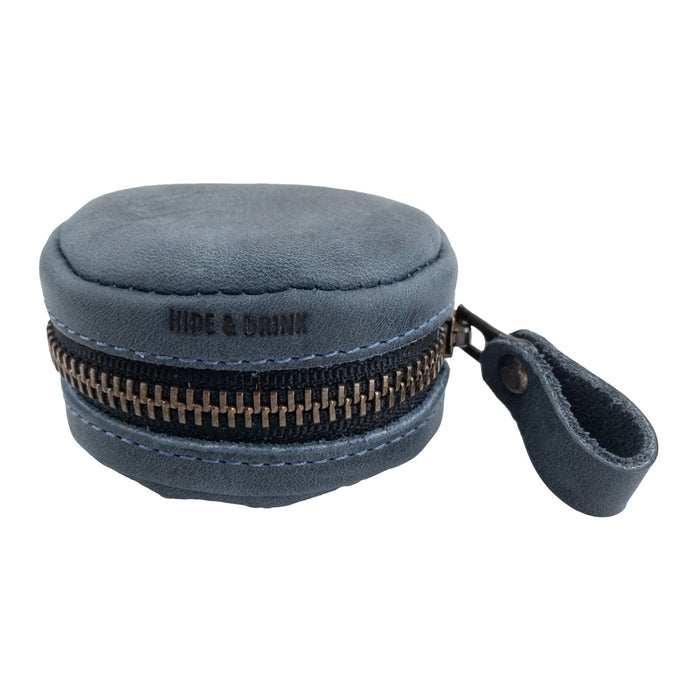 Close-up of the Hide & Drink Rounded Coin Case, revealing its luxurious Full Grain Leather texture. This artisan-crafted item emphasizes small batch production with hand cut, hand sewn elements and fire branding, made by skilled artisans in La Antigua Guatemala & Oaxaca Mexico.