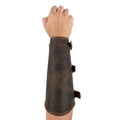 Hand model showcasing the Rustic Archery Bracer by Valhalla Gear, featuring adjustable buckle straps made from durable full grain leather. This forearm protector is perfect for knights and cosplay events. It combines artisan craftsmanship with small batch production, ensuring each piece is handmade in La Antigua Guatemala & Oaxaca Mexico.