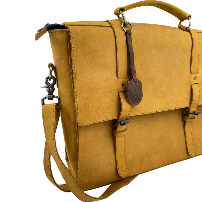 LeatherTex Rustic Strap Keyring for AirTag, displayed on a stylish messenger bag, emphasizing its function as a keychain holder for car and home. This full grain leather key organizer accessory is handcrafted with care in La Antigua Guatemala.