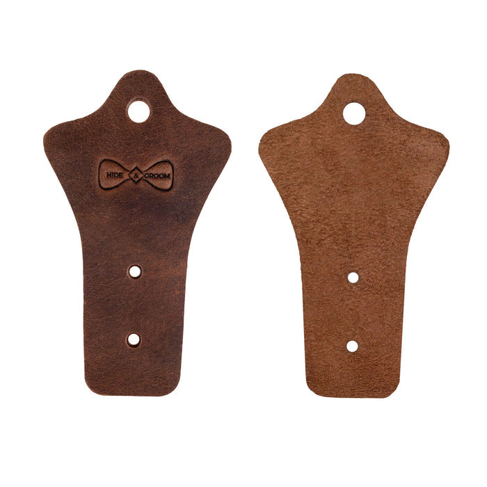 Hide & Groom Set of 2 Buckle Belt Hangers displayed separately, showcasing their beautiful full grain leather craftsmanship. These hangers are perfect for closet or wall mount storage and make memorable gifts for groomsmen. Handmade in La Antigua Guatemala, featuring artisan techniques that reflect quality and dedication.