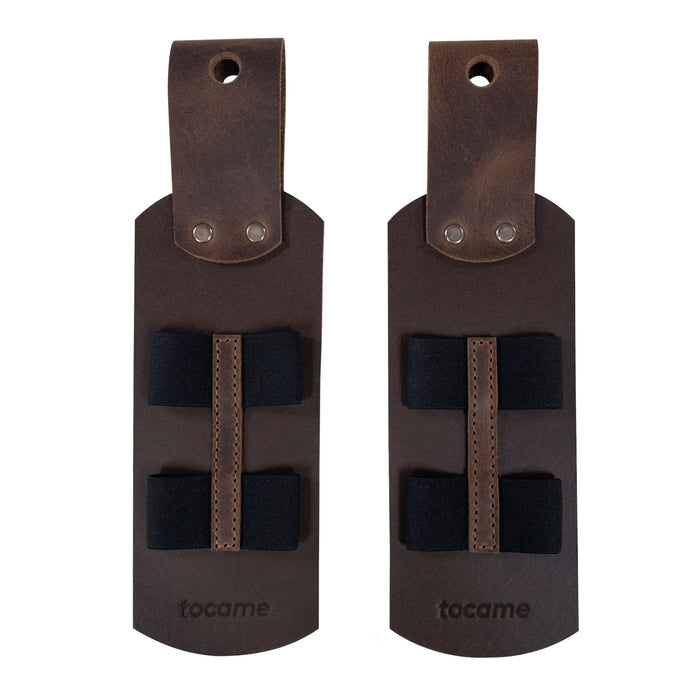 An overhead view of the rustic Set of 2 Drum Stick Sleeves by tocame, displaying the elegant design with elastic straps for secure stick holding. Made from high-quality full grain leather, this stick case epitomizes handmade craftsmanship from artisan producers in La Antigua, Guatemala.