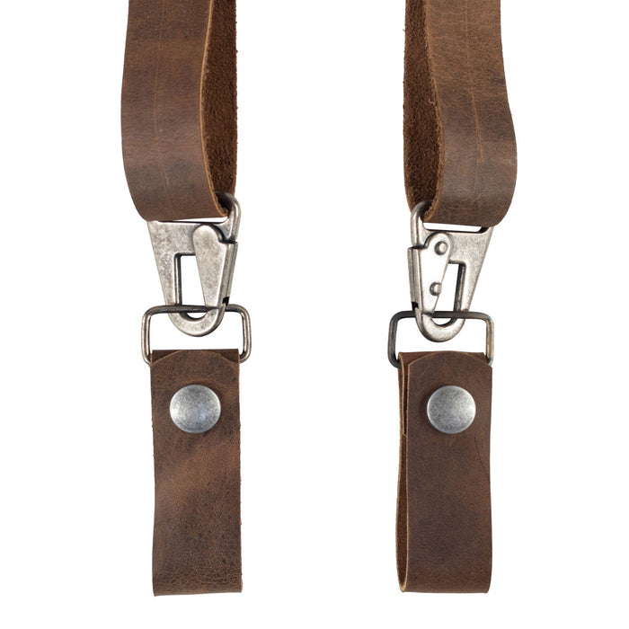 An angled shot of the Set of 2 Suspender Loop Attachments with Snap Closure by Hide & Groom, highlighting the sturdy clips and full grain leather. Set of 2 Suspender Loops Attachment for Men with Snap Closure, Heavy Duty, Wedding Accessories, Full Grain Leather, StockyardX, Small Batch Production, Hand Cut, Hand Sewn, Fire Branded, Artisan, Handmade in La Antigua Guatemala & Oaxaca Mexico.