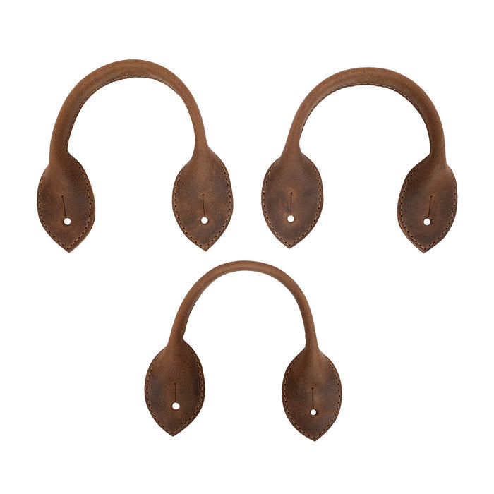Close-up view of the Set of 3 Button End Attachments for Suspenders by Hide & Groom, highlighting the unique shape and full grain leather texture. Great for groomsmen and wedding ceremonies, these hand cut and hand sewn attachments reflect artisan craftsmanship from La Antigua Guatemala.