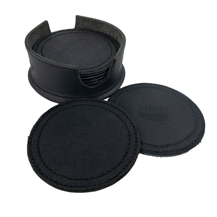 An open leather holder showing multiple coasters from the Set of 8 Circular Coasters for Drinks by Hide & Drink. This set, designed for Glass & Cups Stain Protection, is handmade from rugged Waxed Canvas and Full Grain Leather. Experience the quality of StockyardX with these Small Batch Production coasters that are Hand Cut, Hand Sewn, Fire Branded, and made Artisan, Handmade in La Antigua Guatemala & Oaxaca Mexico.
