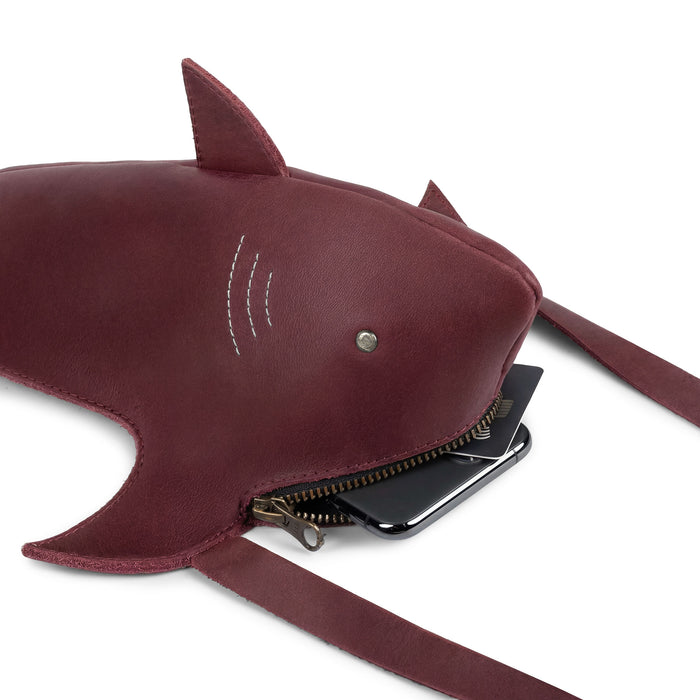 Close-up view of the Shark-Shaped Shoulder Bag by Tudi Frudi revealing its spacious interior and a zippered pocket. This bag is made of Full Grain Leather, hand cut and sewn, exemplifying small batch production and artisan craftsmanship, with versatility for crossbody and messenger functionality.