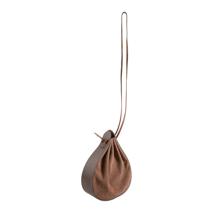 Heather's Shoulder Bag displayed in a creative angle, featuring its multipurpose rounded shape. This full grain leather shoulder bag is ideal for travel and reflects artisan quality through small batch production, hand cut and hand sewn craftsmanship, along with fire branding. Handmade in La Antigua Guatemala & Oaxaca Mexico.