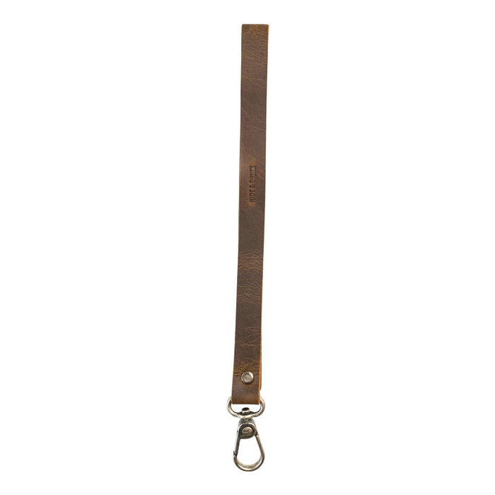 A simple thin lanyard made of Full Grain Leather, showcasing its durable design and artisan craftsmanship by Hide & Drink, perfect for organizing items. This Simple Thin Lanyard features tags such as Small Batch Production, Hand Cut, Hand Sewn, Fire Branded, Artisan, Handmade in La Antigua Guatemala & Oaxaca Mexico.