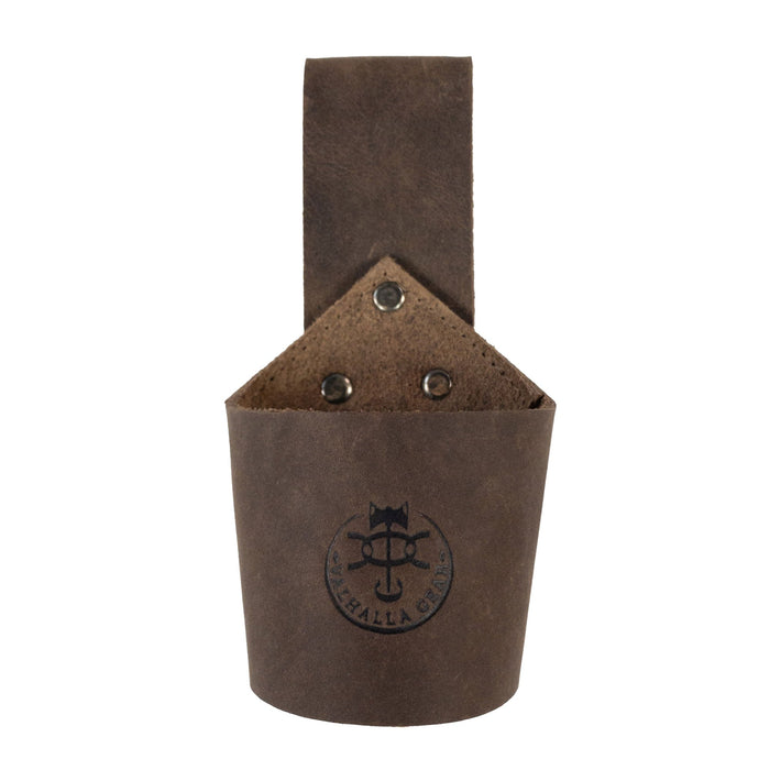 A close-up view of Valhalla Gear's Single Axe Holster emphasizes its durable construction and artisan craftsmanship. This accessory for tools combines functionality with style, featuring a double belt loop for secure carrying. Crafted from full grain leather in La Antigua Guatemala & Oaxaca Mexico, each piece is hand cut, hand sewn, and showcases the commitment to quality in small batch production.