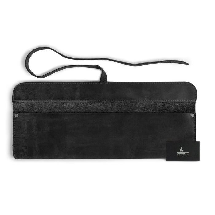 Cast Leather Co. Single Leather Knife Case in black, paired with a business card for brand presentation. This stylish yet functional kitchen small storage bag is an ideal solution for chefs on the go. Made from high-quality full grain leather in La Antigua Guatemala, it reflects the artistry of handmade craftsmanship.