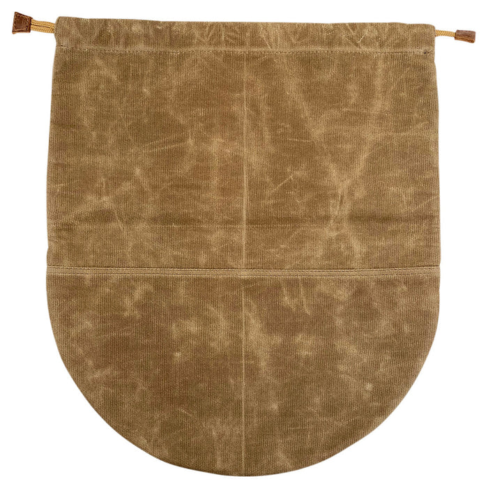 The Skillet Bag Cover by Hide & Drink displayed flat, showcasing its simple yet effective design. Made from waxed canvas, this case for skillet without nonstick coating features artisan craftsmanship, with hand cut and hand sewn details, handmade in La Antigua Guatemala and Oaxaca Mexico.