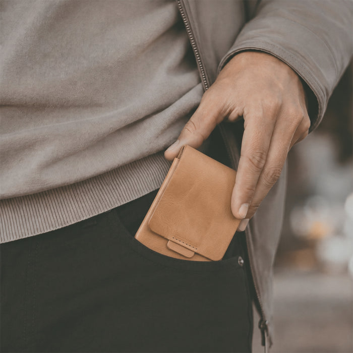 Hide & Drink Slim Card Holder in brown, showing its practical design for organizing cards and cash. This artisan crafted vertical wallet emphasizes quality full grain leather and handmade production from La Antigua Guatemala.