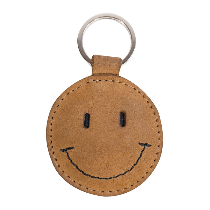 Front view of the Smiley Face Keychain by Hide & Drink featuring its cheerful smile design. Made from quality Full Grain Leather, this key holder combines fun with functionality. An excellent gift choice for various occasions, showcasing handmade artisan care from Oaxaca Mexico.