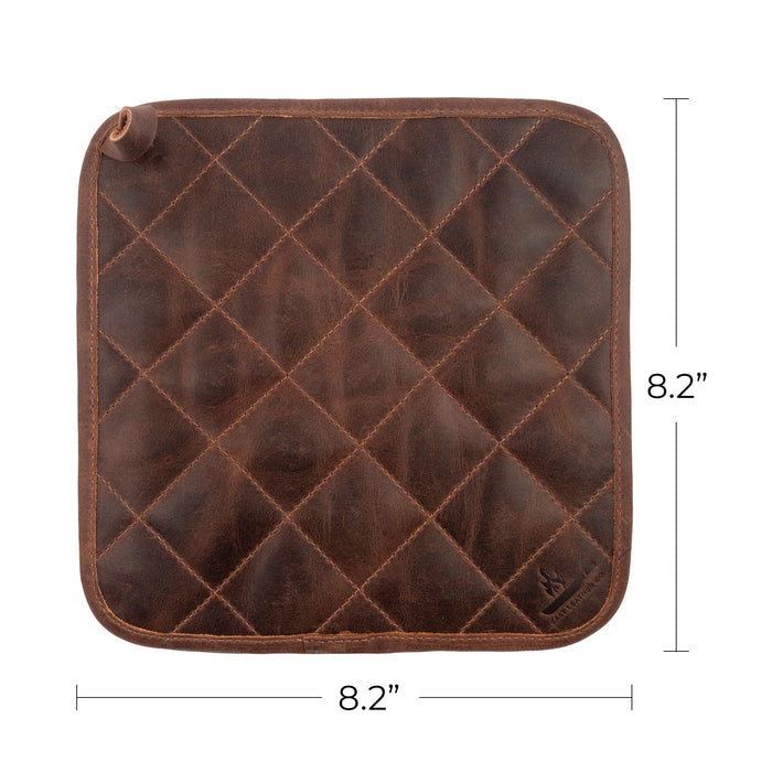 The Cast Leather Co. Squared Hot Pot Pad with measurement details displayed next to it, illustrating its practical size. This Squared Oven Mitt Heat Resistant, Hot Pot Pad (Potholder) is vital for bakery supplies, made from full grain leather and sheepskin. Crafted via small batch production, this handmade item is fire branded and produced by artisans in La Antigua Guatemala & Oaxaca Mexico.