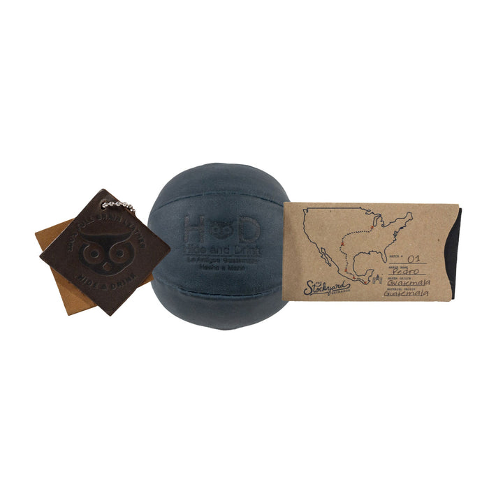 Hide & Drink navy Stress Ball dimensions highlighted, showing its compact size of 2.5 inches for easy portability. Great for relieving fidgeting and anxiety while showcasing classic design, handcrafted in La Antigua Guatemala.