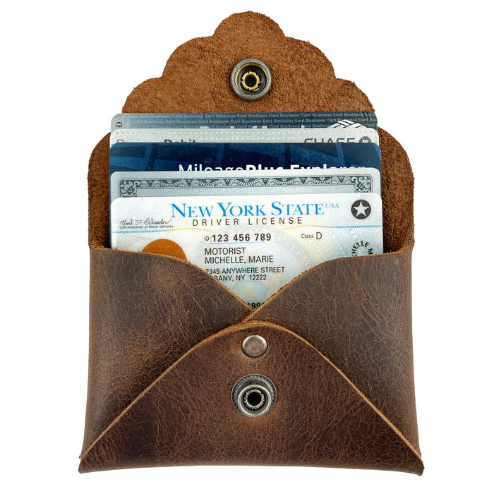 The Stylish Envelope by Heather's with cards inserted, demonstrating its practicality as a classy organizer. This compact storage solution for debit and credit cards is made from premium full grain leather, crafted through small batch production with meticulous hand cutting and sewing, fire branded for quality, and handmade in La Antigua Guatemala & Oaxaca Mexico.