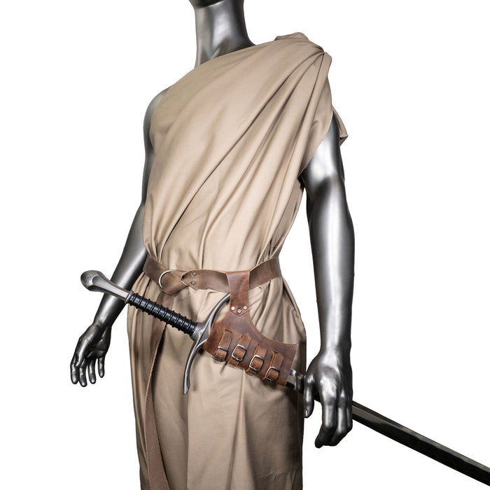 A mannequin wearing the Sword Frog Leather Holder by Hide & Play, elegantly displaying its utility and aesthetic appeal as a costume accessory. Made from durable full grain leather, this artisan product features small batch production techniques, hand cut and fire branded in La Antigua Guatemala and Oaxaca Mexico.