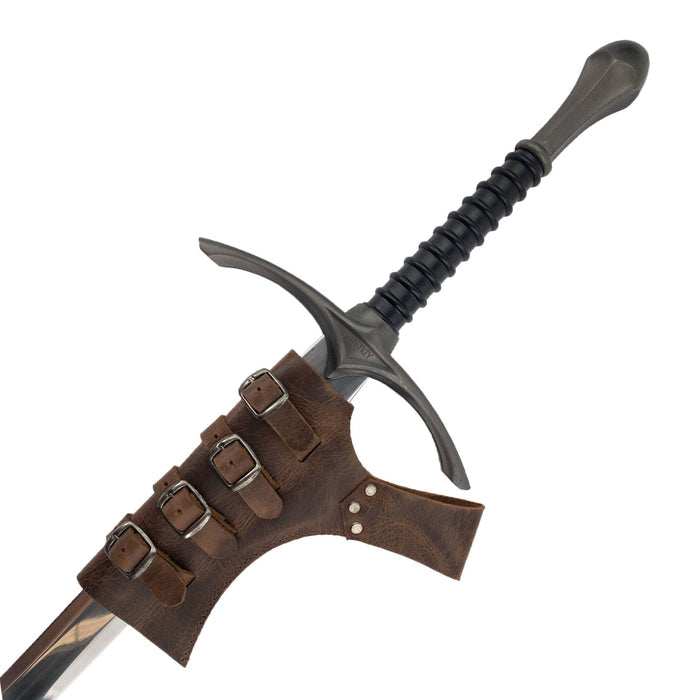 The Sword Frog Leather Holder by Hide & Play presented with a sword, emphasizing its unique design. This medieval sword holder crafted from full grain leather is ideal for cosplay or costume use, showcasing the quality of artisan techniques with small batch production in La Antigua Guatemala & Oaxaca Mexico.