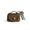 Tiny Handbag Keychain by Hide & Drink, showcasing a stylish Tiny Handbag with Key Ring Holder made from Full Grain Leather. This artisan piece represents Small Batch Production, and is Hand Cut, Hand Sewn, and Fire Branded. It is proudly Handmade in La Antigua Guatemala & Oaxaca Mexico.