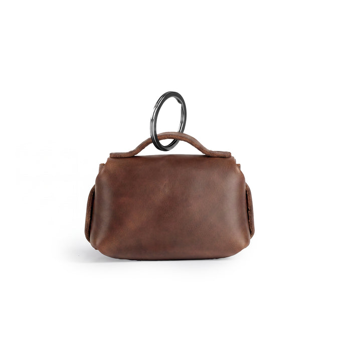 Back view of the Tiny Handbag Keychain, emphasizing its sleek design and key ring holder, created with full grain leather by Hide & Drink. This Tiny Handbag with Key Ring Holder represents small batch production, hand cut, hand sewn, and fire branded artistry, all handmade in La Antigua Guatemala & Oaxaca Mexico.