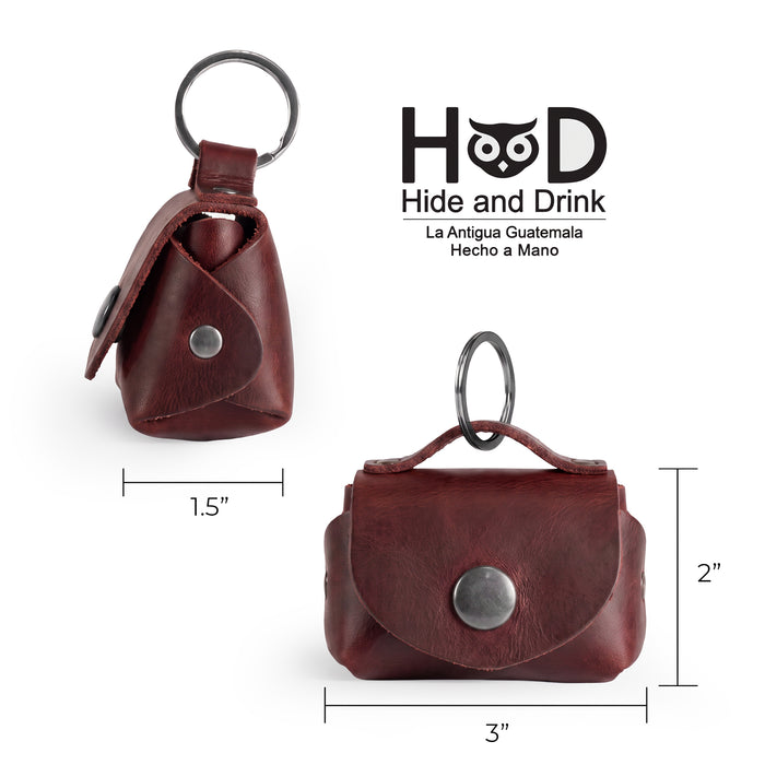Dimensions of the Tiny Handbag Keychain by Hide & Drink displayed alongside a ruler, measuring 3 inches by 2 inches. This artisan-crafted keychain features a robust Full Grain Leather design and represents small batch production techniques.