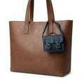 The deep blue Tiny Messenger Bag by Hide & Drink, a unique Mini Messenger Bag Charm crafted from rich Full Grain Leather. This artisanal piece is perfect as a keychain or handbag accent, showcasing meticulous handmade quality from La Antigua Guatemala.