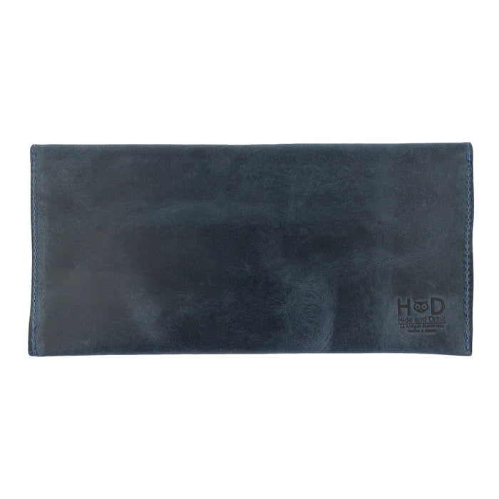 The back of Hide & Drink's navy blue Travel Hand Wallet, displaying its high-quality Full Grain Leather finish. A durable Travel Wallet, this artisan piece is hand sewn in La Antigua Guatemala & Oaxaca Mexico.