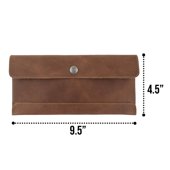 Size comparison of Hide & Drink's brown Travel Hand Wallet with dollar bills placed alongside, highlighting its dimensions and Full Grain Leather design. This Travel Wallet is crafted artisan-style in La Antigua Guatemala & Oaxaca Mexico.
