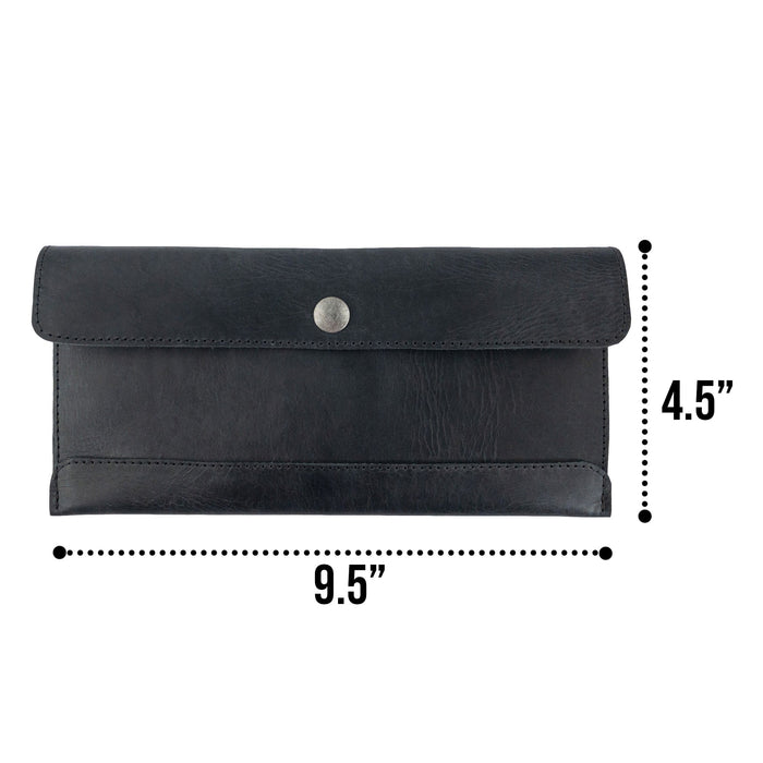 Size comparison of Hide & Drink's black Travel Hand Wallet next to a measuring tape, highlighting its dimensions and Full Grain Leather quality. This Travel Wallet is hand sewn and artisan-made in La Antigua Guatemala & Oaxaca Mexico.