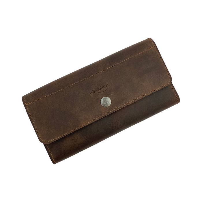 Heather's Tri Fold Folio Wallet, a Minimalist Tri Fold Folio Wallet for Women, features a stylish button closure and is made of durable full grain leather. Perfect for organizing cards and cash, this chic wallet is hand cut and hand sewn by artisans, ensuring quality in small batch production in La Antigua Guatemala & Oaxaca Mexico.