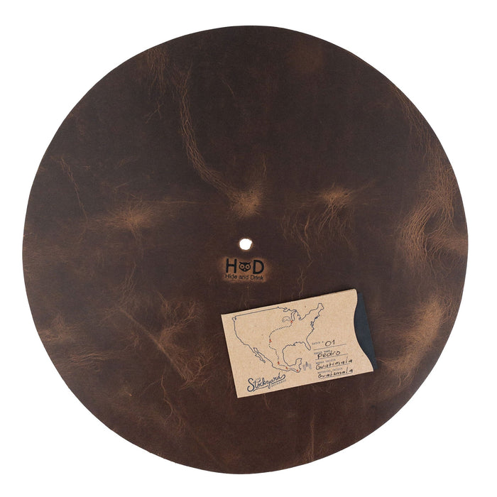Hide & Drink Turntable Slipmat presenting detailed craftsmanship, made from durable full grain leather with a fire branded logo. This classy turntable slipmat not only reduces noise and static but also adds a unique, handmade artisan touch to any vinyl collection.